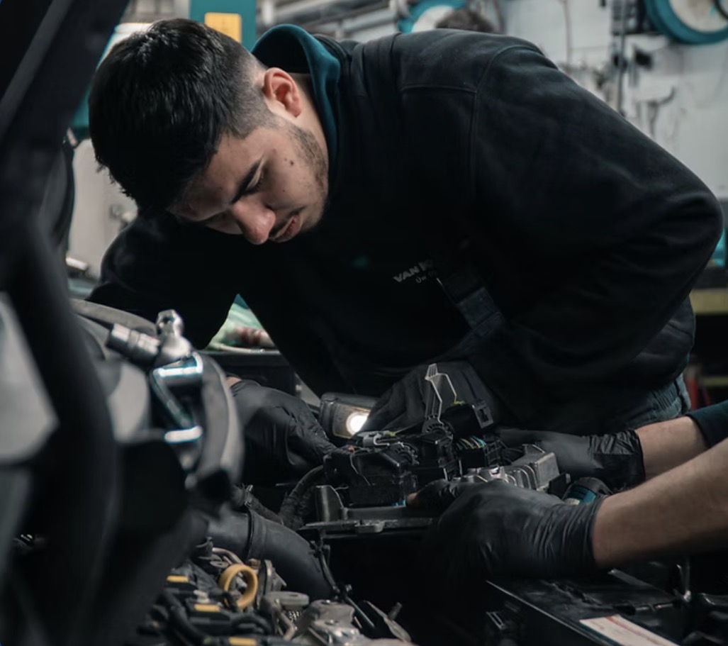 Mobile mechanic working in engine bay